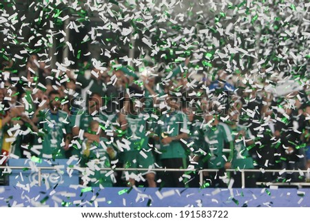 ATHENS, GREECE APRIL 26, 2014 : Players of Panathinaikos lift the Cup after their win over Paok during the Greek Cup Final match Paok vs Panathinaikos. Focus is on the confetti