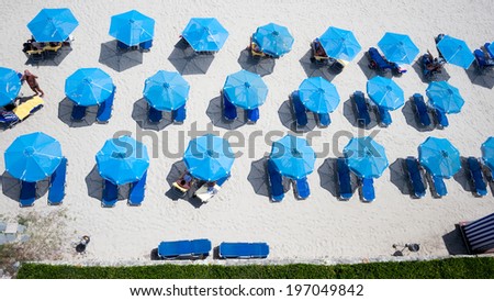 Top view of beach with tourists, sunbeds and umbrellas. Sea travel destination.