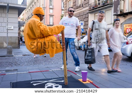 NAPLES, ITALY- AUGUST 3, 2014: Street performer in Naples, Italy. Every day, street performers try their hand at making a living from tips on Naples, Italy.
