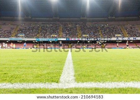 NAPLES, ITALY- AUGUST 2, 2014:  Wide view of the game and the stadium during the friendly match Napoli vs Paok. Focus on the line, shallow depth of field.