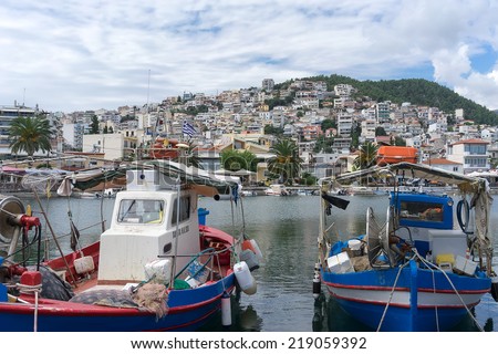 KAVALA, GREECE- SEPTEMBER 5, 2014: The traditional Greek fishing boats in the harbor of Kavala in Greece. The harbor is the focal point for recreational, commercial, business and tourist activity.