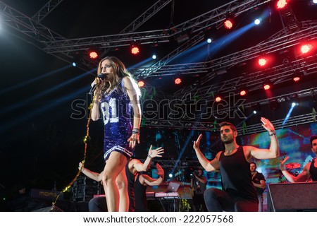 THESSALONIKI, GREECE, SEPTEMBER 11, 2014: Singer Despina Vandi  performing at MAD North Stage festival by Thessaloniki International Fair. Blur stage spotlights with laser rays in the background.