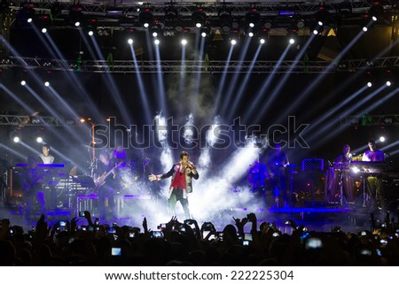 THESSALONIKI GREECE SEPTEMBER 11 2014 Singer Sakis Rouvas performing at MAD North Stage festival by Thessaloniki International Fair Blur stage spotlights with laser rays in the background THESSALONIKI GREECE SEPTEMBER 11 2014 Singer Sakis Rouvas performing at MAD North Stage festival by Thessaloniki International Fair Blur stage spotlights with laser rays in the background