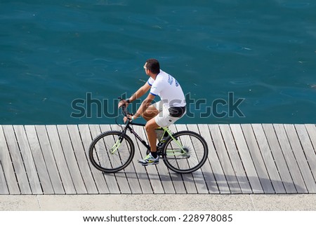 THESSALONIKI, GREECE - OCTOBER 17, 2014: Unidentified man rides bicycle in Thessaloniki, Greece. Bike riding became official Olympic sport in the 2008 Summer Olympic Games in Beijing, China.