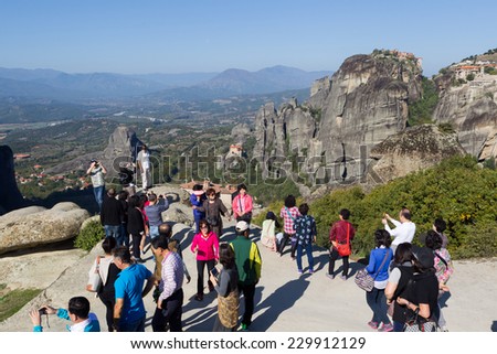 METEORA, GREECE - OCTOBER 12, 2014: Tourists taking pictures during their tour at Meteora, Greece.