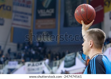 THESSALONIKI, GREECE - JAN 21, 2015: The referee holding a ball up during the Eurocup game Paok vs Khimki in Paok Sports Arena.