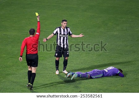 THESSALONIKI, GREECE NOVEMBER 9, 2014 : The referee shows the yellow card to a player during the Greek Superleague match PAOK vs Panathinaikos