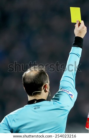 THESSALONIKI, GREECE FEBRUARY 8, 2015 : The referee shows the yellow card during the Greek Superleague match PAOK vs Olympiacos