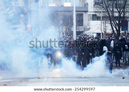 THESSALONIKI, GREECE FEBRUARY 8, 2015 : Police is fighting with the protester fans prior to the Greek Superleague match PAOK vs Olympiacos