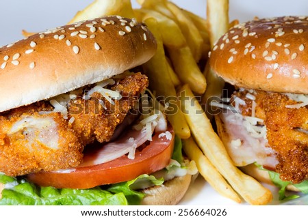 Big hamburger with chicken and french fries