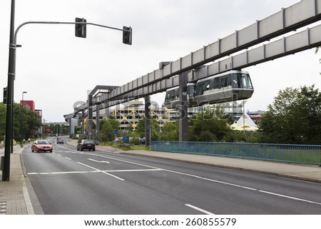 DUSSELDORF, GERMANY- JULY 5, 2012: Public transportation system Sky-Train hanging from elevated guideway beam on columns in Dusseldorf, Germany. The SkyTrain, takes passengers to the airport terminal.