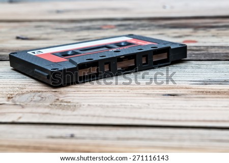 Vintage audio cassette  on a wooden background.
