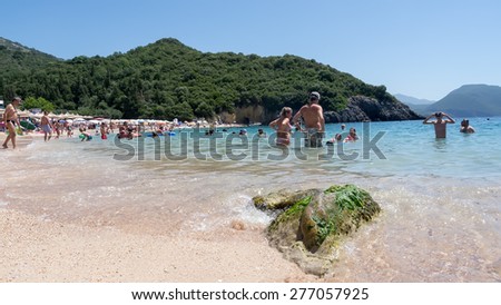 PARGA, GREECE- AUGUST 16, 2014: People relaxing on the Lichnos beach in a hot day of summer in Parga, Greece.