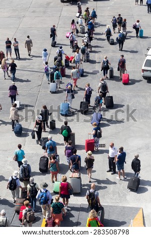 PAROS, GREECE, MAY 17, 2015: Passengers disembark from the ship at the port of Paros in Greece .The Paros is an island in Cyclades that accepts too many tourists every year