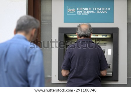 THESSALONIKI, GREECE,JUN 27 2015: People stand in a queue to use the ATMs of a bank. Greece\'s fraught bailout talks with its creditors took a dramatic turn, with the government announcing a referendum