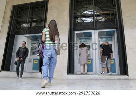 THESSALONIKI, GREECE,JUN 27 2015: People stand in a queue to use the ATMs of a bank. Greece\'s fraught bailout talks with its creditors took a dramatic turn, with the government announcing a referendum