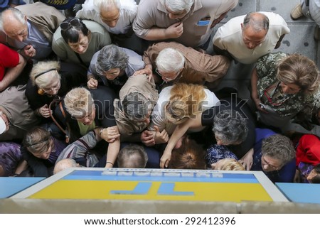 THESSALONIKI, GREECE, JULY, 1 2015: Pensioners queue outside a National Bank branch as banks only opened for the retired to allow them to cash up to 120 euros in Athens