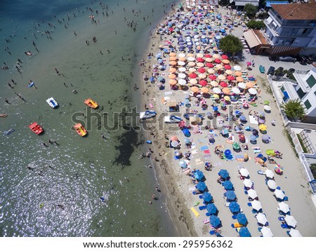 KATERINI, GREECE, JULY 5 2015: Aerial view of the beach of Katerini in Greece. colorful umbrellas and people who swims. Aerial shot