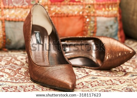 Beautiful brown bride\'s shoes on the bed