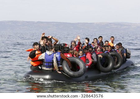 Lesbos, Greece, Oktober 11 2015: Refugees and Migrants aboard dinghies reach the Greek Island of Lesbos after crossing the Aegean sea from Turkey