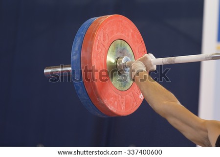 Thessaloniki, Greece, Oct 3 2015: Hands on the barbell. Young athlete getting ready to lift the weights during the course of the Greek Weightlifting Championship