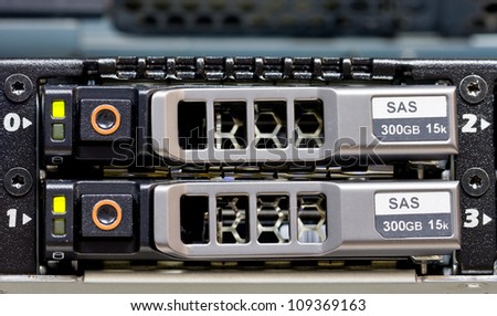 Row of hard drives mounted in a rack in a data center