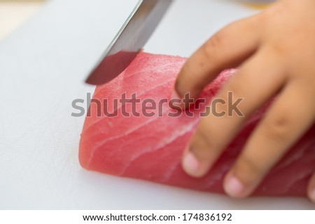 Hand was sliced ??fish to make sushi