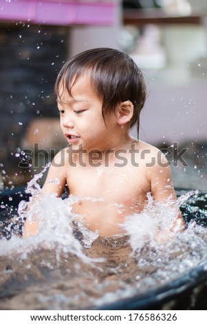 Asian Boys playing with water