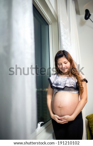 Beautiful Asian woman with a pretty smile. 're Happy with pregnancy