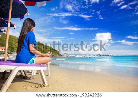 Meditation - Meditation girl yoga on the beach at dawn. Woman relaxing in lotus pose in the Zen calm sea.