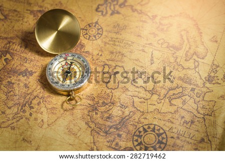 Old compass on vintage map.