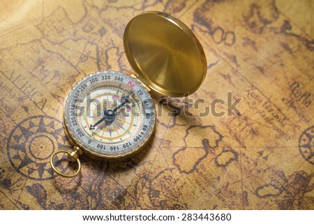 Old compass on vintage map.
