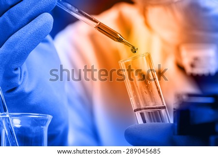 Hands of clinician holding tools during scientific experiment in laboratory