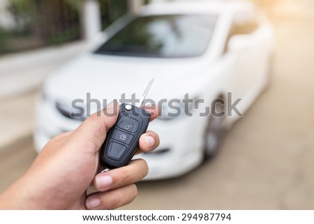 hand presses on the remote control car alarm systems