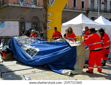 BARI, ITALY - March 8, 2015: Volunteers of the Civil Protection dismantled a tent during the Deejay Ten Bari organized by Linus and Radio Deejay.