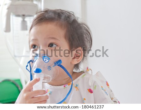 Little boy sick in hospital with a respiratory mask