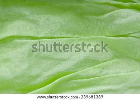creased fabric background in green color