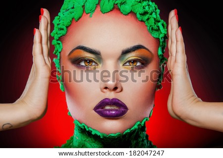 Girl looking at camera with creative makeup in studio