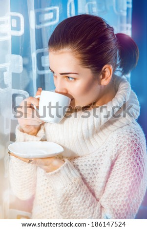 Sweet woman drink coffee from cup