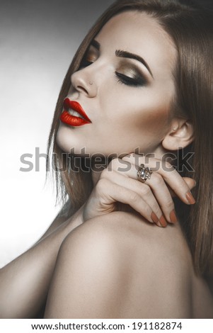 High society woman with closed eyes and makeup in studio