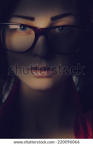 Pretty girl in glasses in shadows lines in studio