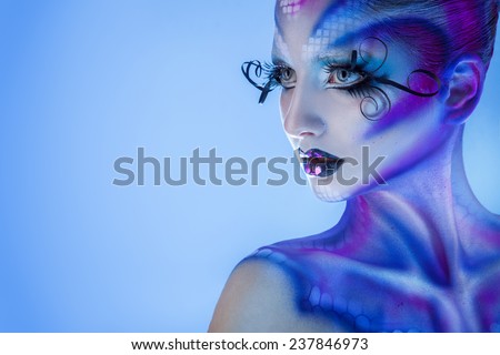 High society woman with creative body art looking away in studio
