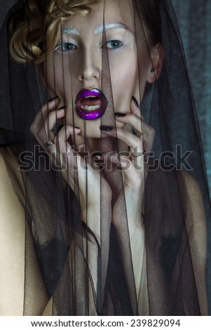 Sexual adult woman with lace on face looking away. studio shot
