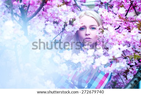 Lady with flowers looking at camera. Spring time. Outdoors