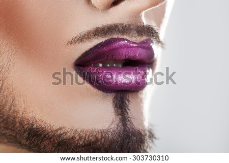 Closeup photo of bearded male lips with makeup. macro. horizontal.