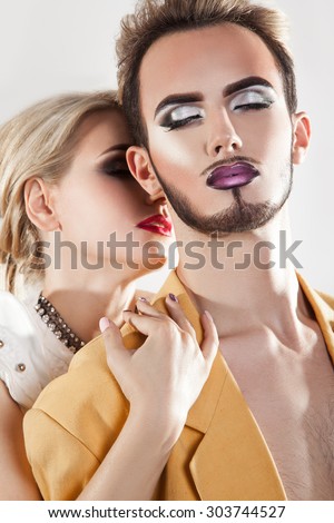 Sensuality couple in love. Both with nice makeup. Studio shot. Vertical.