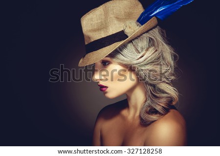 Profile portrait of beauty woman with grey hair color and nice makeup in hat on black background