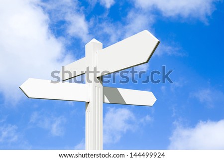 Blank wooden signpost with four arrows over blue sky - just add your text.