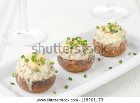 Stuffed mushrooms, baked with cheese and herbs, selective focus on center mushroom