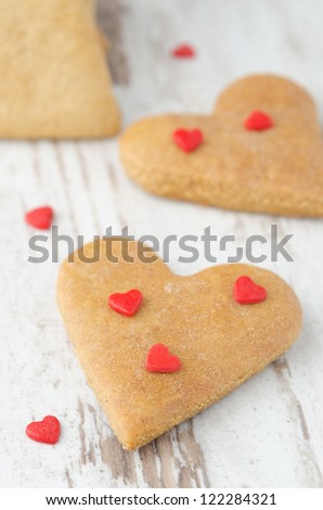 cookies in the shape of a heart on the table, closeup, scattered sugar hearts